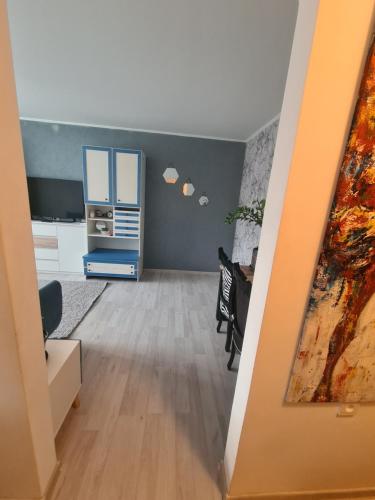 a living room with a desk and a dresser at Blue apartment in Šiauliai