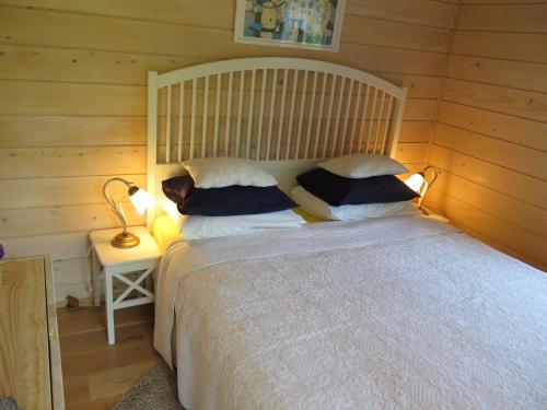 a bedroom with a large bed and a table with a lamp at Apartments Montana in Fužine