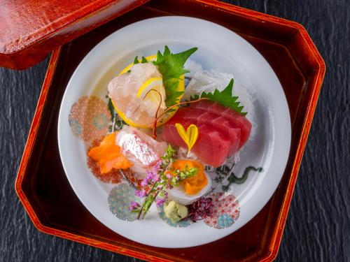 a white plate of food in a red tray at Ryoso Uminocho in Ise