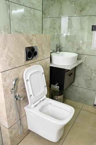 a bathroom with a toilet and a sink at Wayanad Farm Heritage in Sultan Bathery