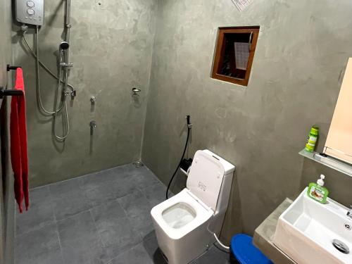 a bathroom with a toilet and a shower and a sink at Green nature in Mirissa