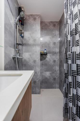 a bathroom with a shower and a sink at Cebu Serene Quarters with City View in Mactan Island