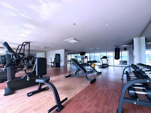 a gym with treadmills and elliptical machines at Playful 1BR With Magnificant Bayview Garden View Near Okada Solaire Aiports with Free Parking in Manila