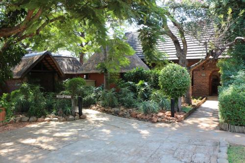 a house with a garden in front of it at Mohlabetsi Safari Lodge in Hoedspruit