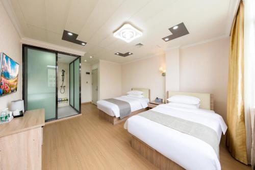 Ein Bett oder Betten in einem Zimmer der Unterkunft Shiyi Business Hotel Pazhou-Free shuttle bus for canton fair
