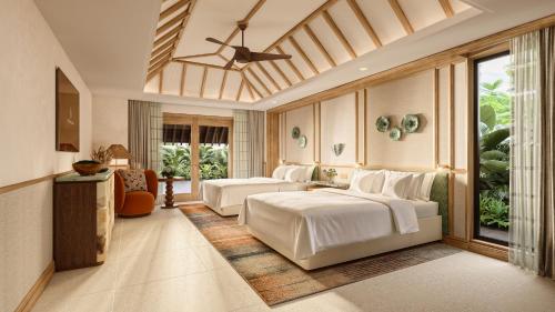 a bedroom with two beds in a room at Four Seasons Resort Mauritius at Anahita in Beau Champ