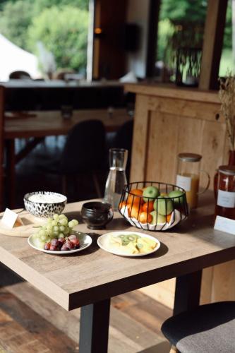 a wooden table with plates of fruit on it at Le Domaine de Bra in Bra