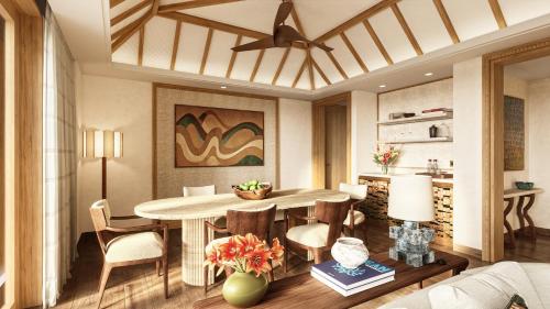 a living room with a dining room table and chairs at Four Seasons Resort Mauritius at Anahita in Beau Champ