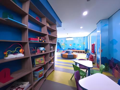 a childs room with a table and chairs at Playful 1BR With Magnificant Bayview Garden View Near Okada Solaire Aiports with Free Parking in Manila