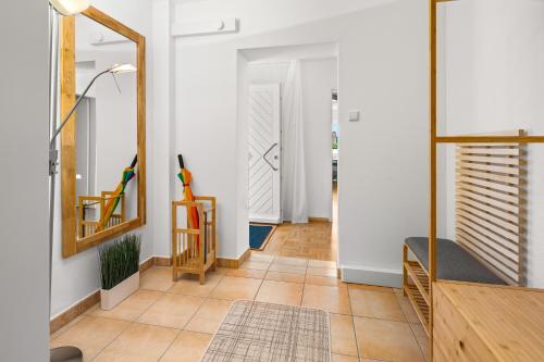 a hallway with a mirror and a chair at Ferienwohnung Magnolie - Gaggenau in Gaggenau