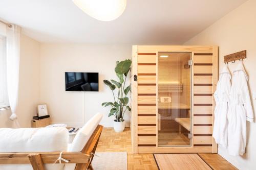 a bedroom with a large wooden closet at L'Escapade Secrète balnéo - sauna - love room in Arras