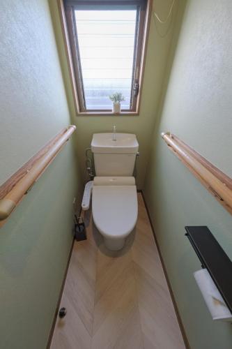 a small bathroom with a toilet with a window at 65m2 Free parking Modern Japanese style Toys for kids Great sunlight Kids can relax in Kasukabe