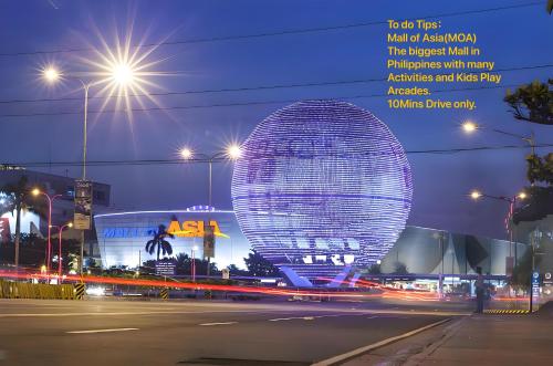 a large building in a city at night at Playful 1BR With Magnificant Bayview Garden View Near Okada Solaire Aiports with Free Parking in Manila
