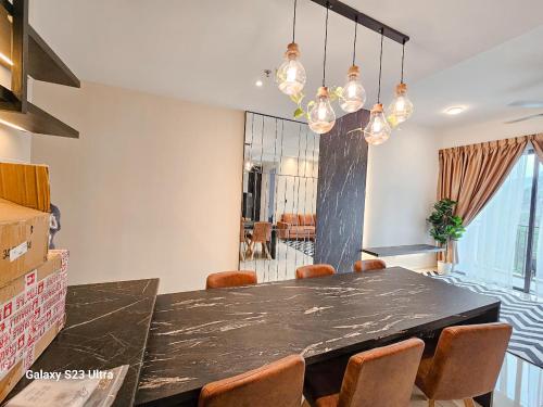 a dining room with a black table and chairs at Onsen Premium Hotspring Suite Sunway Tambun Ipoh in Tambun