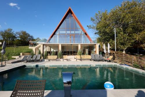 a house with a pool with chairs and a building at OneLife Retreat 