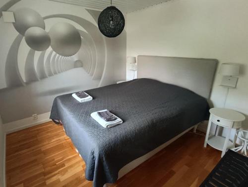 a bedroom with a bed with a black comforter at Comfortable apartment in Nyköping