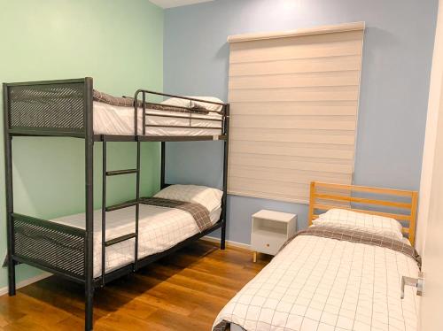 two bunk beds in a room with a bed at Onsen Premium Hotspring Suite Sunway Tambun Ipoh in Tambun