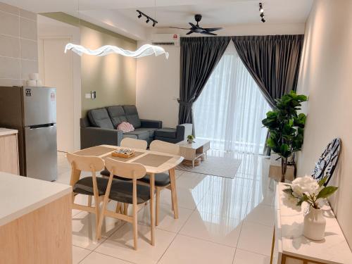 a kitchen and living room with a table and a couch at Onsen Premium Hotspring Suite Sunway Tambun Ipoh in Tambun