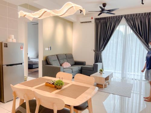 a living room with a table and a couch at Onsen Premium Hotspring Suite Sunway Tambun Ipoh in Tambun