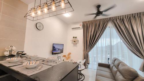 a living room with a table and a couch at Onsen Premium Hotspring Suite Sunway Tambun Ipoh in Tambun
