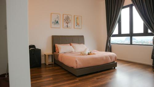 a bedroom with a bed with a stuffed animal on it at Onsen Premium Hotspring Suite Sunway Tambun Ipoh in Tambun