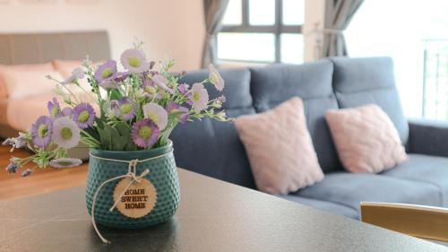 a vase filled with flowers sitting on a table at Onsen Premium Hotspring Suite Sunway Tambun Ipoh in Tambun
