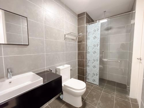 a bathroom with a toilet and a sink and a shower at Onsen Premium Hotspring Suite Sunway Tambun Ipoh in Tambun