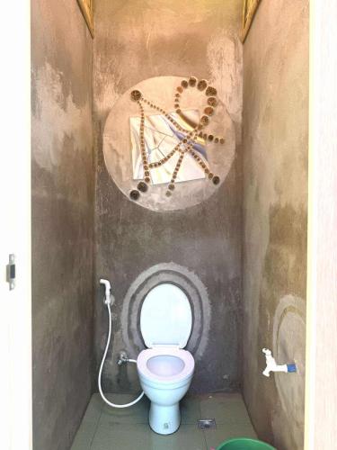 a bathroom with a toilet with a sign on the wall at Jonny's Hostel in San Juan