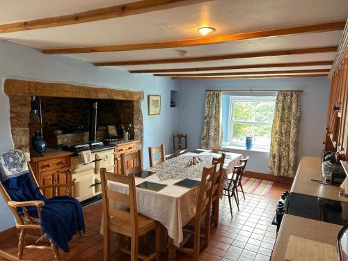 a kitchen and dining room with a table and chairs at Beautiful farmhouse on a hill in Sandford