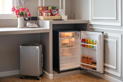 a refrigerator with its door open in a kitchen at Grandbangsaray in Na Jomtien