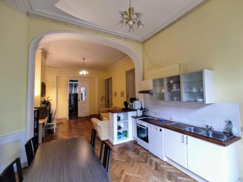 a kitchen with a table and a dining room at Bright 1BR with terrace near Montgomery in Brussels