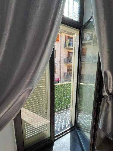 a room with a window with a view of a courtyard at Holiday Home Old Street in Scafati