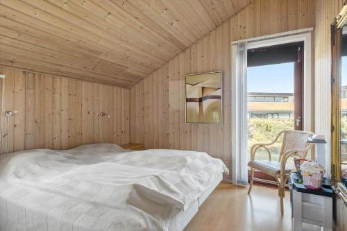 a bedroom with a bed and a table and a window at OH490-Hadsund-Halvrebene-76 in Hadsund
