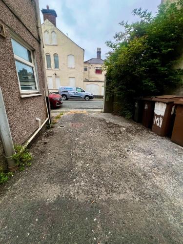 an empty parking lot next to a building at Modern 1 Bedroom Apartment - The Den in Plymouth