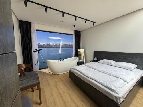 a bedroom with a bathtub and a bed and a bath tub at Diamond LunaMi in Sevan