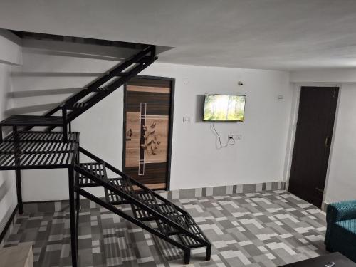 a staircase in a living room with a stair case at Tulip - Duplex on the Terrace in Guwahati
