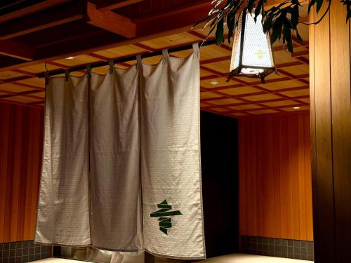 a stage with a curtain with a sign on it at soyo-ne kyoto sanjo in Kyoto