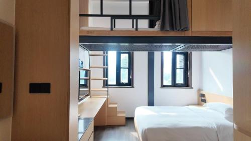 a bedroom with two beds and a loft bed at WeLight Hotel in Beijing