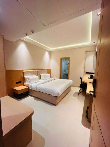 a hotel room with a bed and a desk at Nirvana Nest in Lucknow