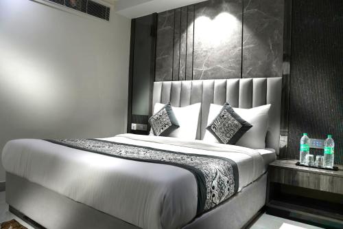 a bedroom with a large white bed with a headboard at Hotel Mountain Bliss' New Delhi City center in New Delhi