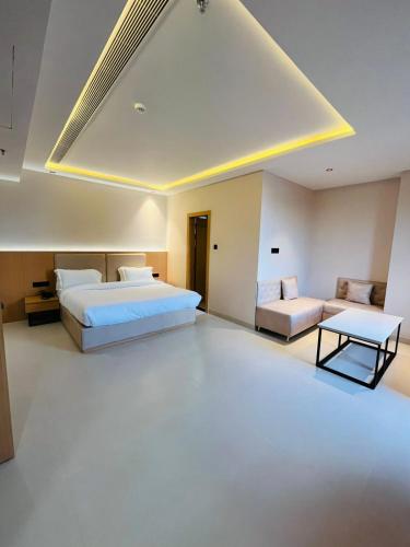 a hotel room with two beds and a couch at Nirvana Nest in Lucknow