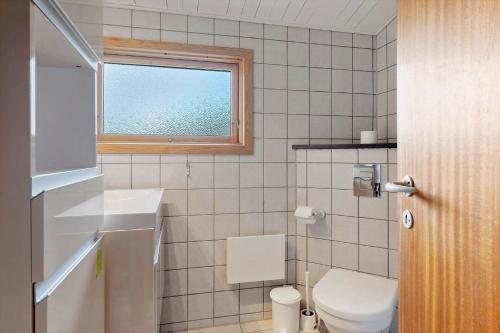 a bathroom with a toilet and a window at OH456-Storvorde-Kystvej-173 in Storvorde