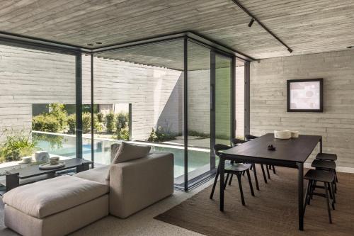 a living room with a couch and a table and a pool at Tranquil Designer Stay with Infinity Pool in Merchtem