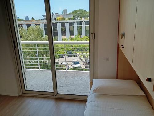 a room with a bed and a large window at Modern and bright apartment in Rome