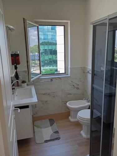 a bathroom with a toilet and a sink and a shower at Modern and bright apartment in Rome