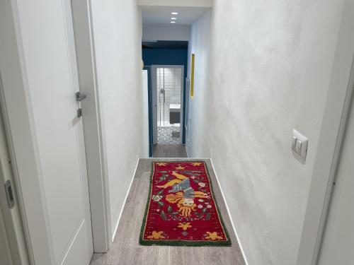 a hallway with a rug on the floor next to a door at Magione 10 in Siena