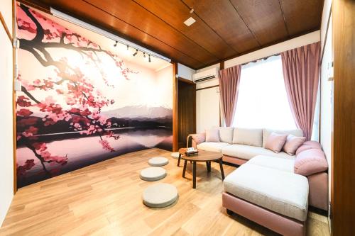 a living room with a couch and a painting at SAKURA-nagoya in Nagoya