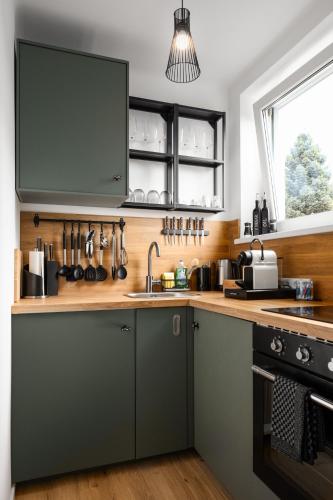 a kitchen with a sink and a window at Stylisches Apartment in Linz mit Netflix & Balkon in Linz