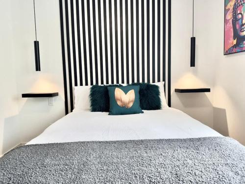 a bedroom with a large bed with a large headboard at Levis Downtown New Studio #3 AC, WiFi and 2 Parking spaces in Lévis