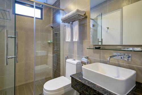 a bathroom with a sink and a toilet and a shower at Highland Breeze Hotel in Genting Highlands